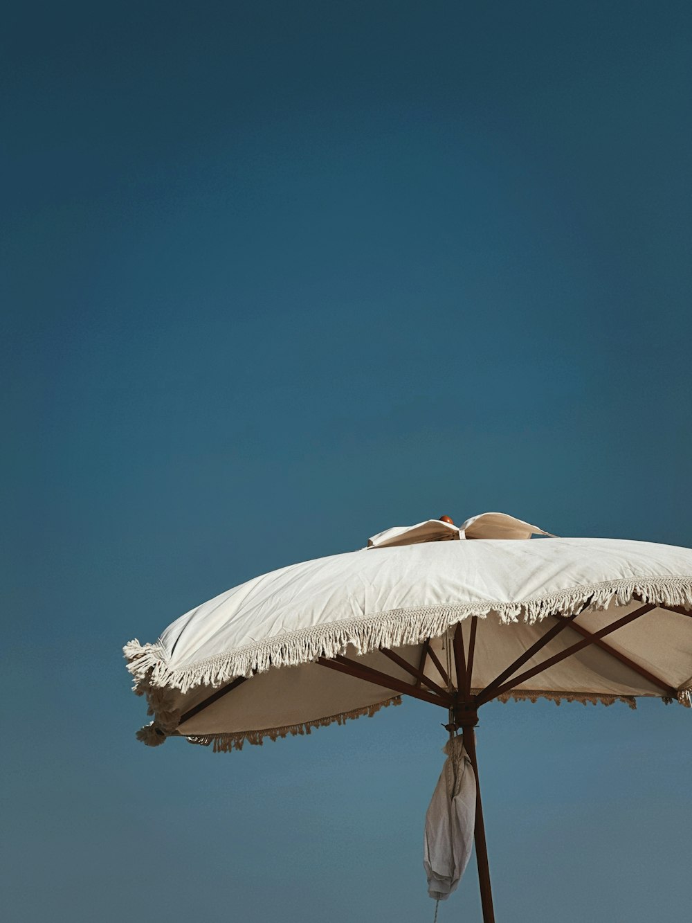 a white umbrella with a white cloth covering it