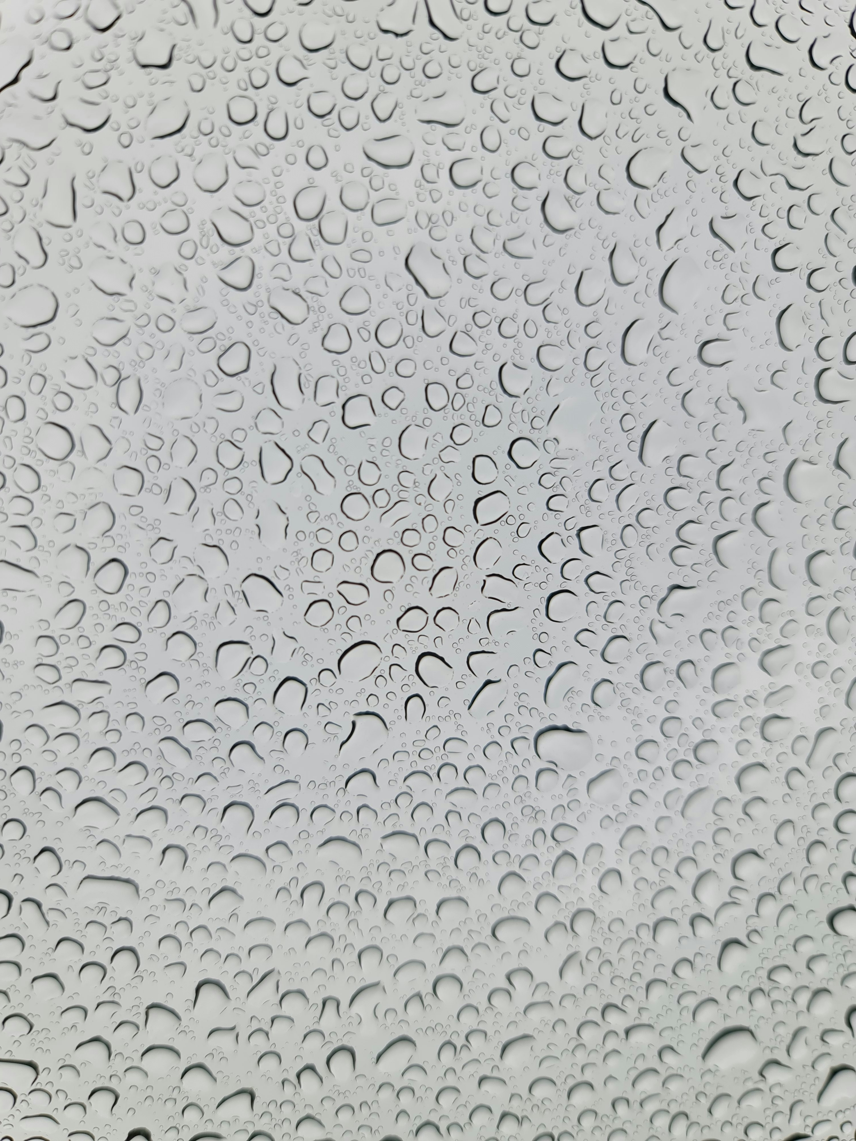 a close up of a window with drops of water on it