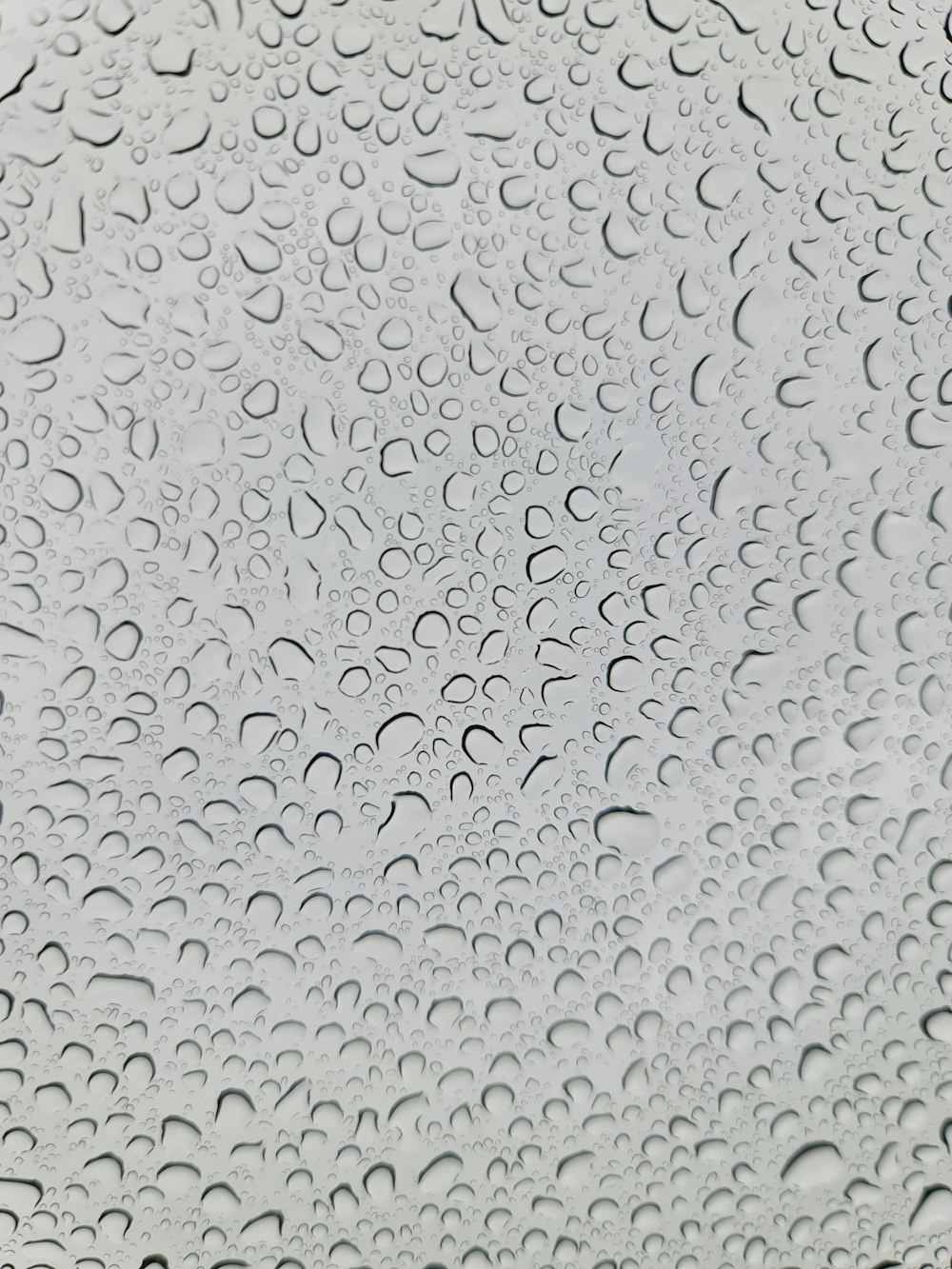 a close up of a window with drops of water on it