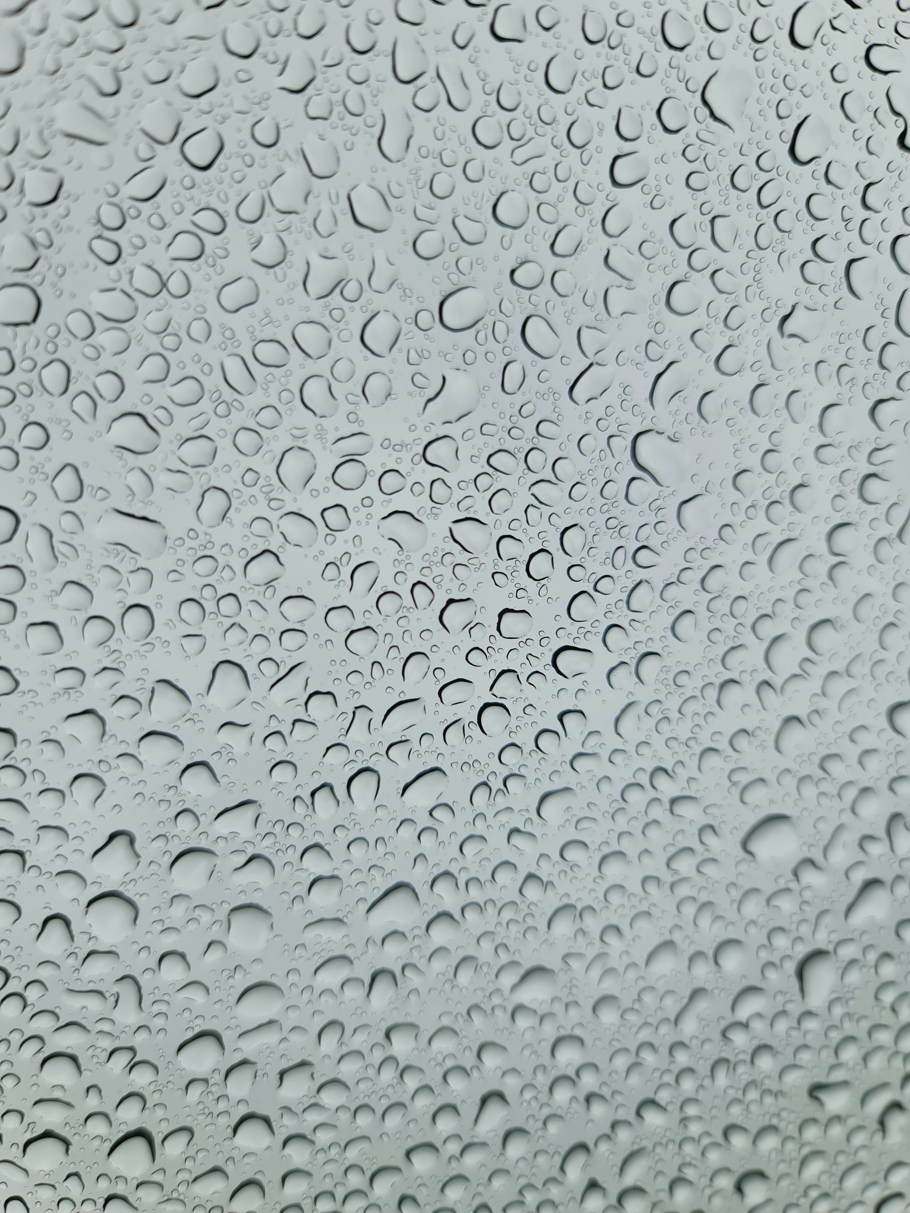 a close up of a window with drops of water on it