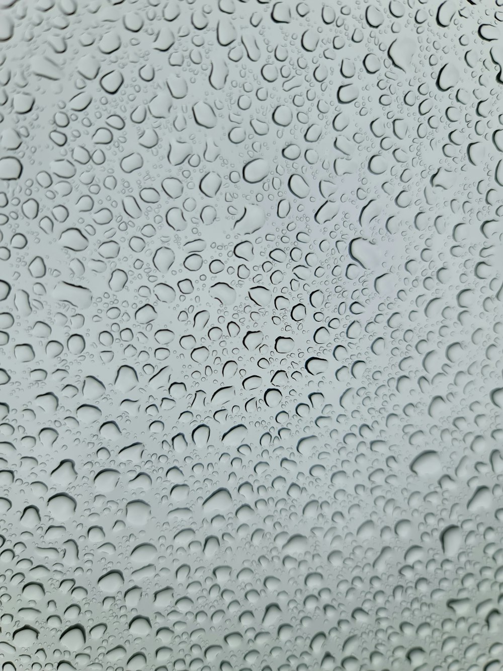 a close up of a window with drops of water on it