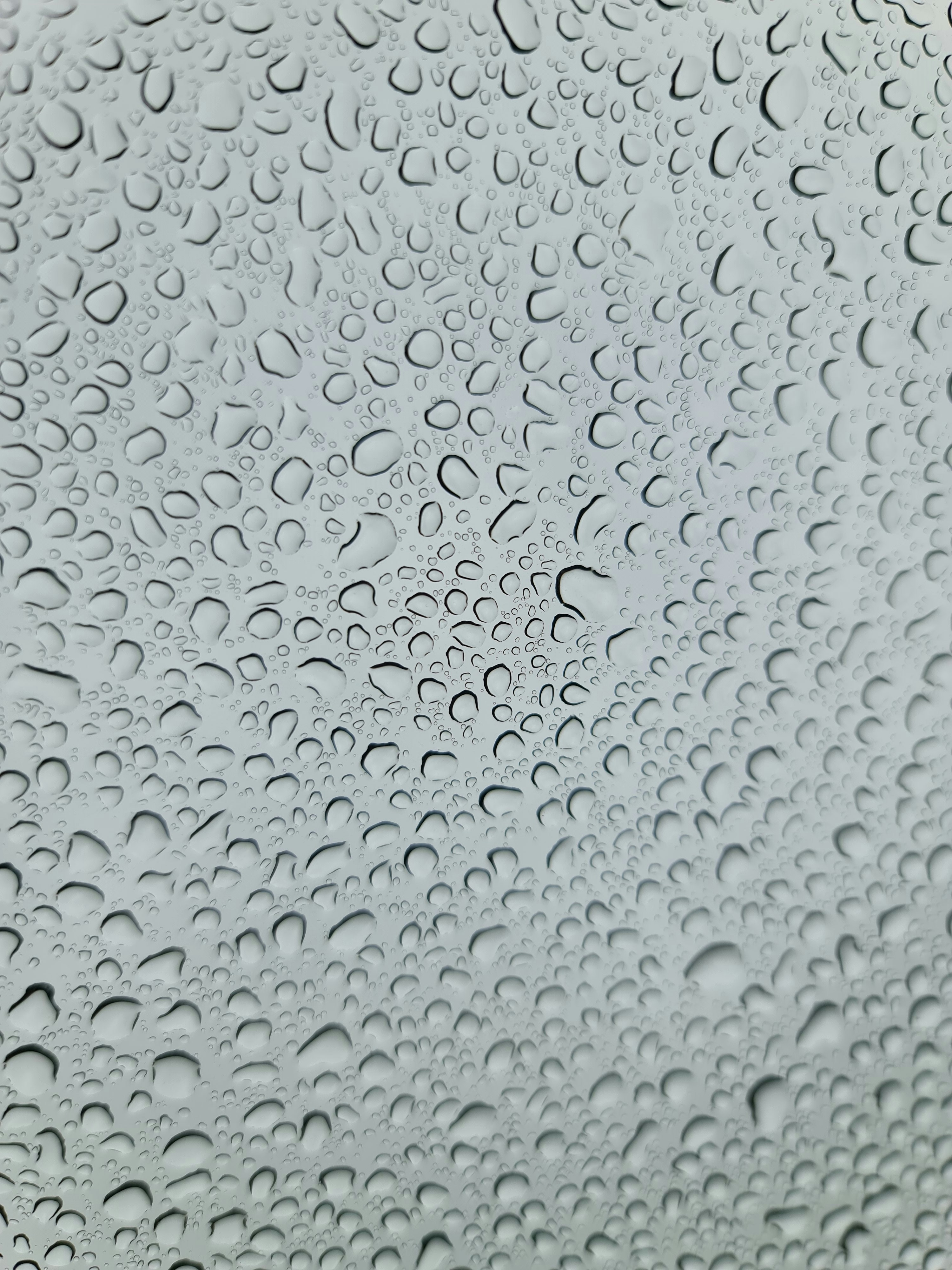 a close up of a window with drops of water on it