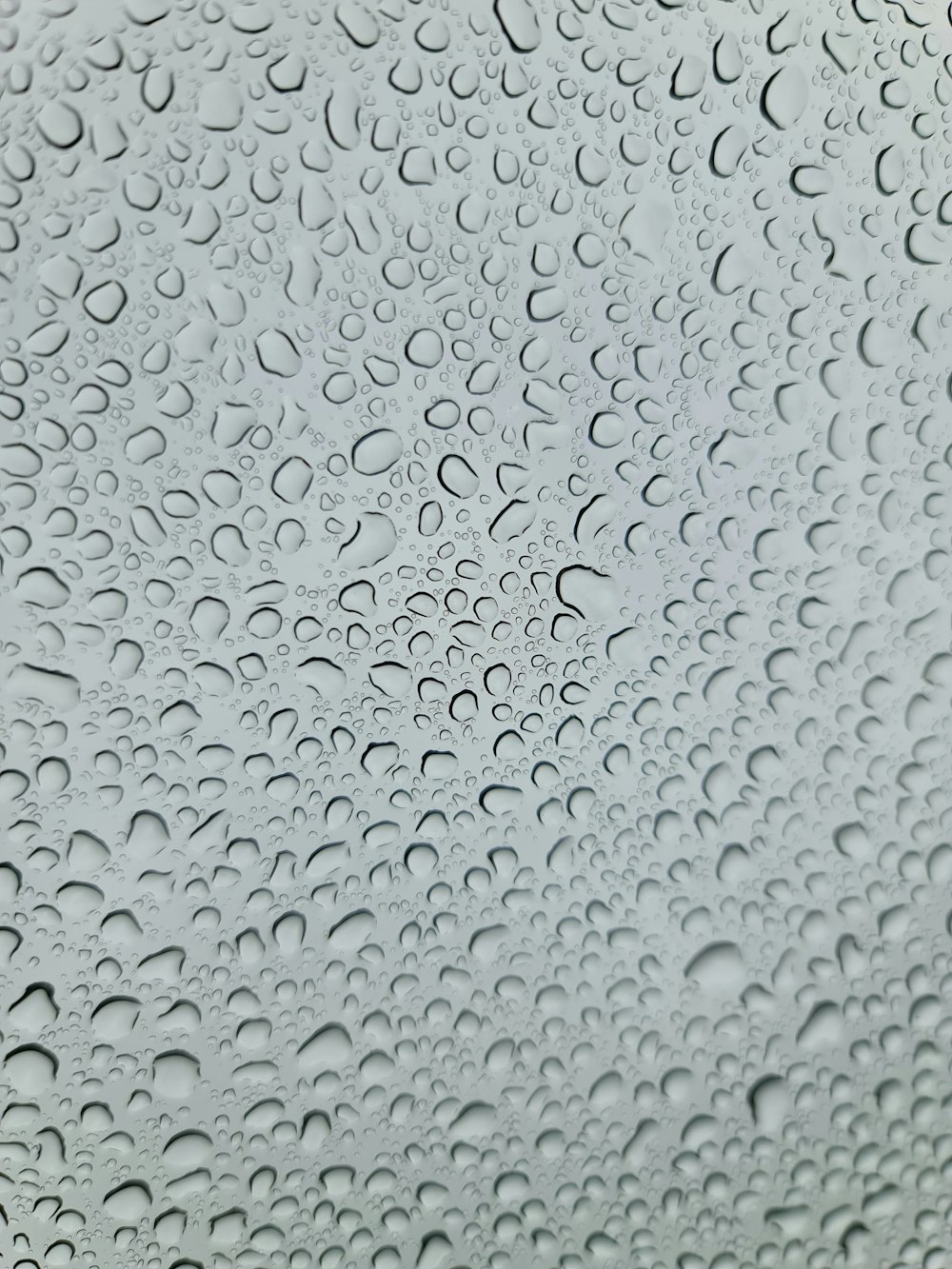 a close up of a window with drops of water on it