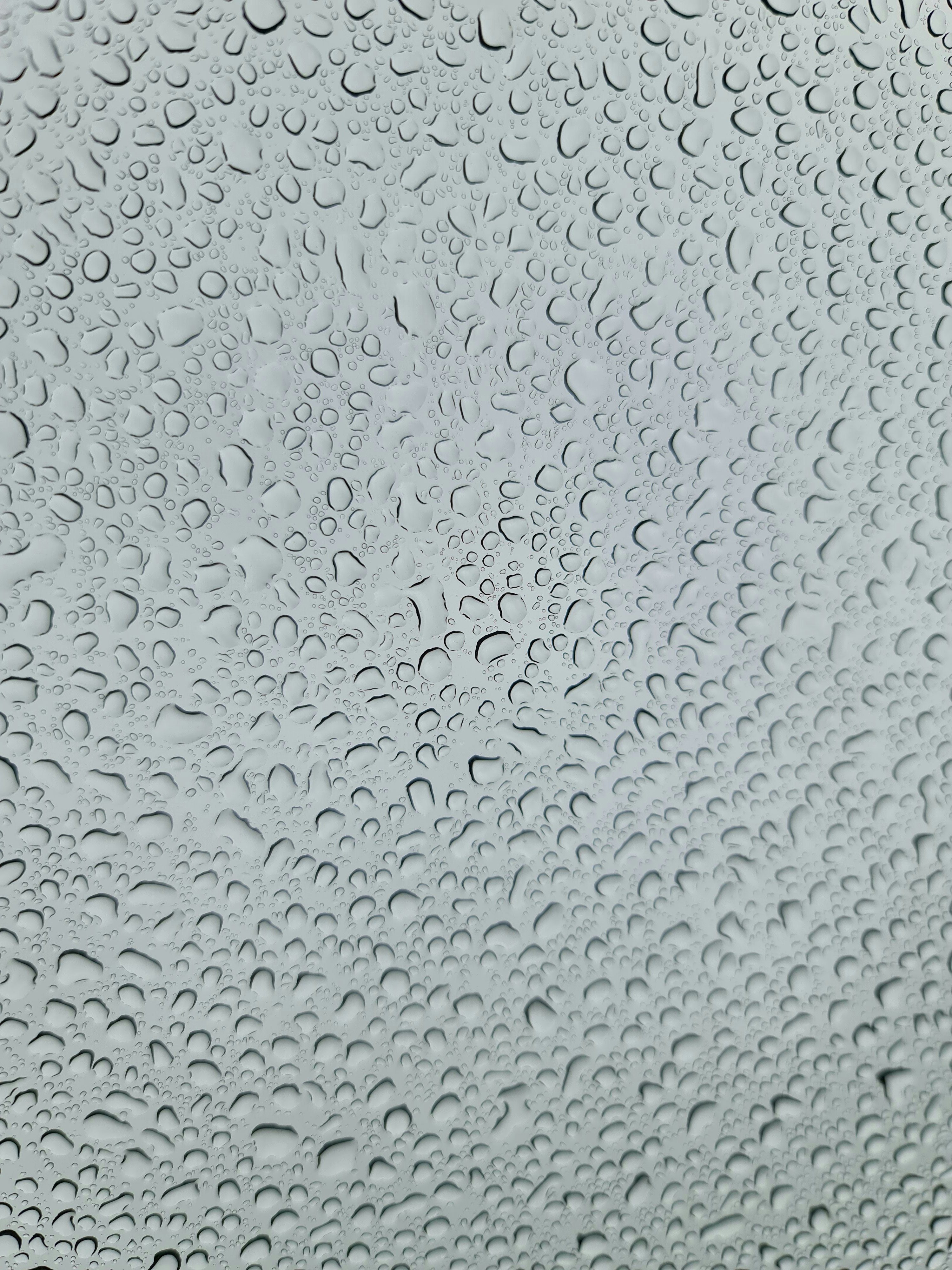 a close up of a window with rain drops on it