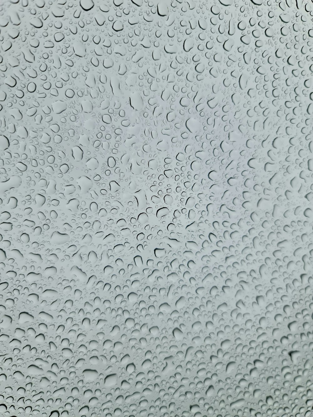 a close up of a window with rain drops on it