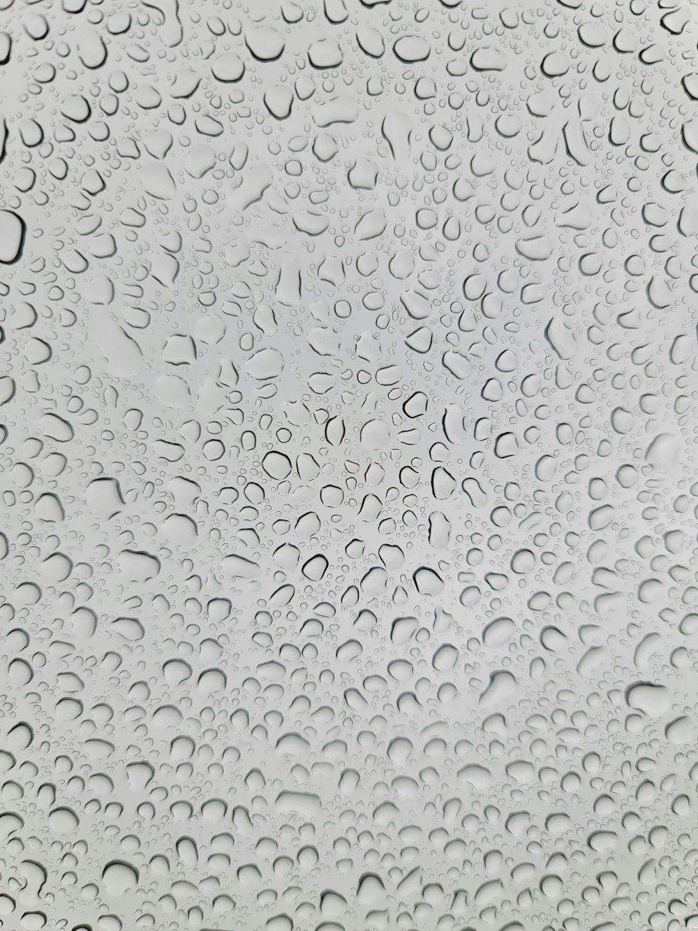 a close up of a window with drops of water on it