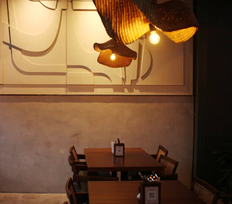 A stylish dining area showcasing fabric dining chairs around a wooden table under warm pendant lights.