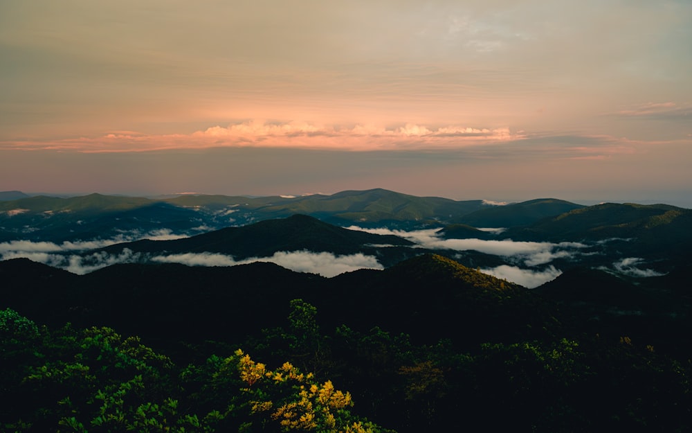 a view of a mountain range with low lying clouds