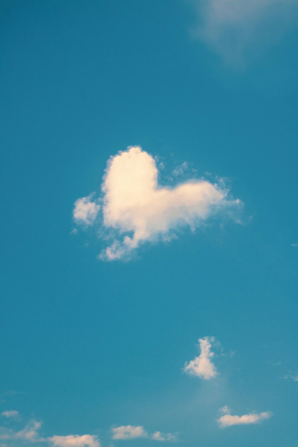 a cloud shaped like a heart in a blue sky