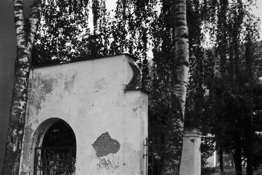 a black and white photo of a building with graffiti on it