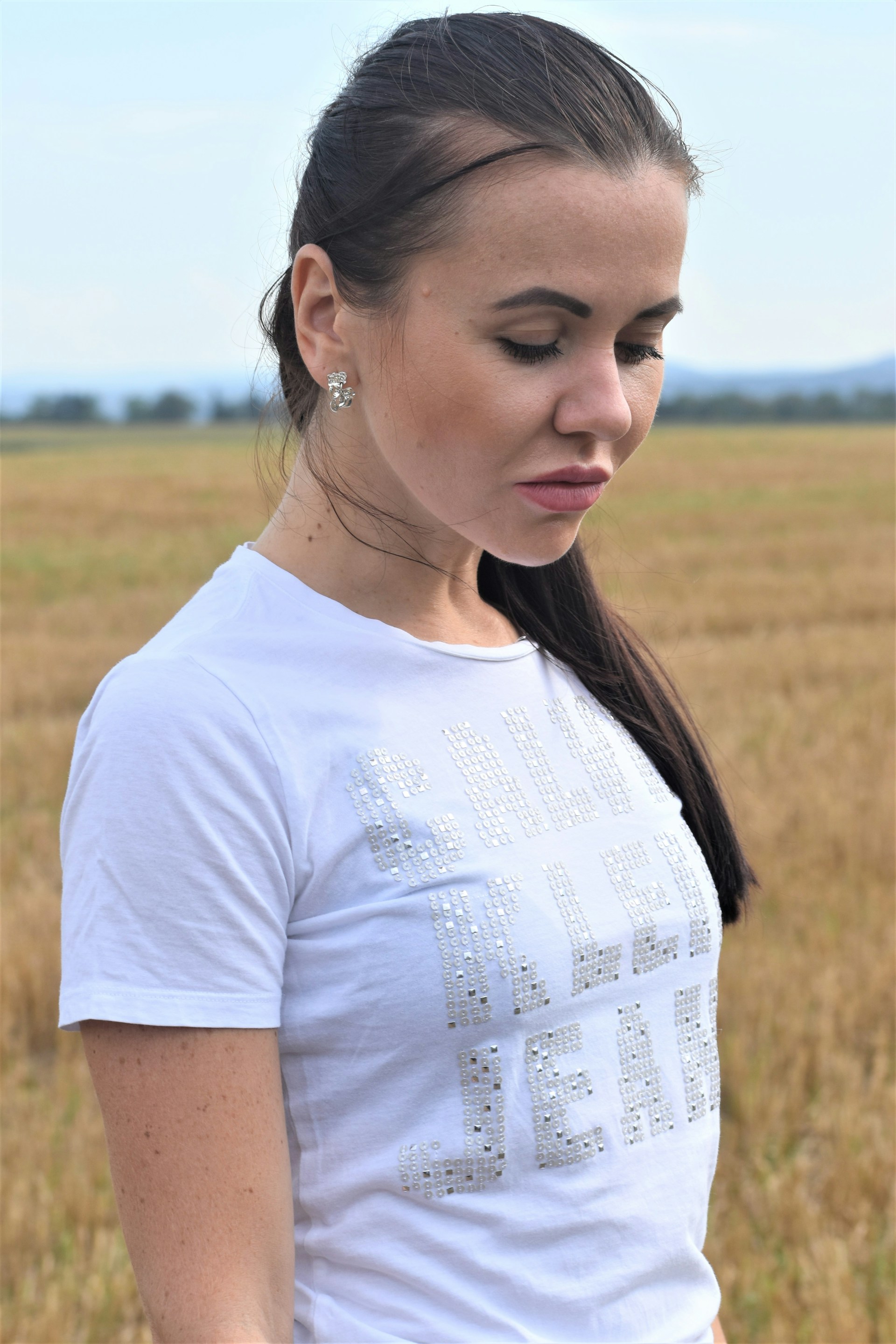 woman wearing yellow long-sleeved dress under white clouds and blue sky during daytime