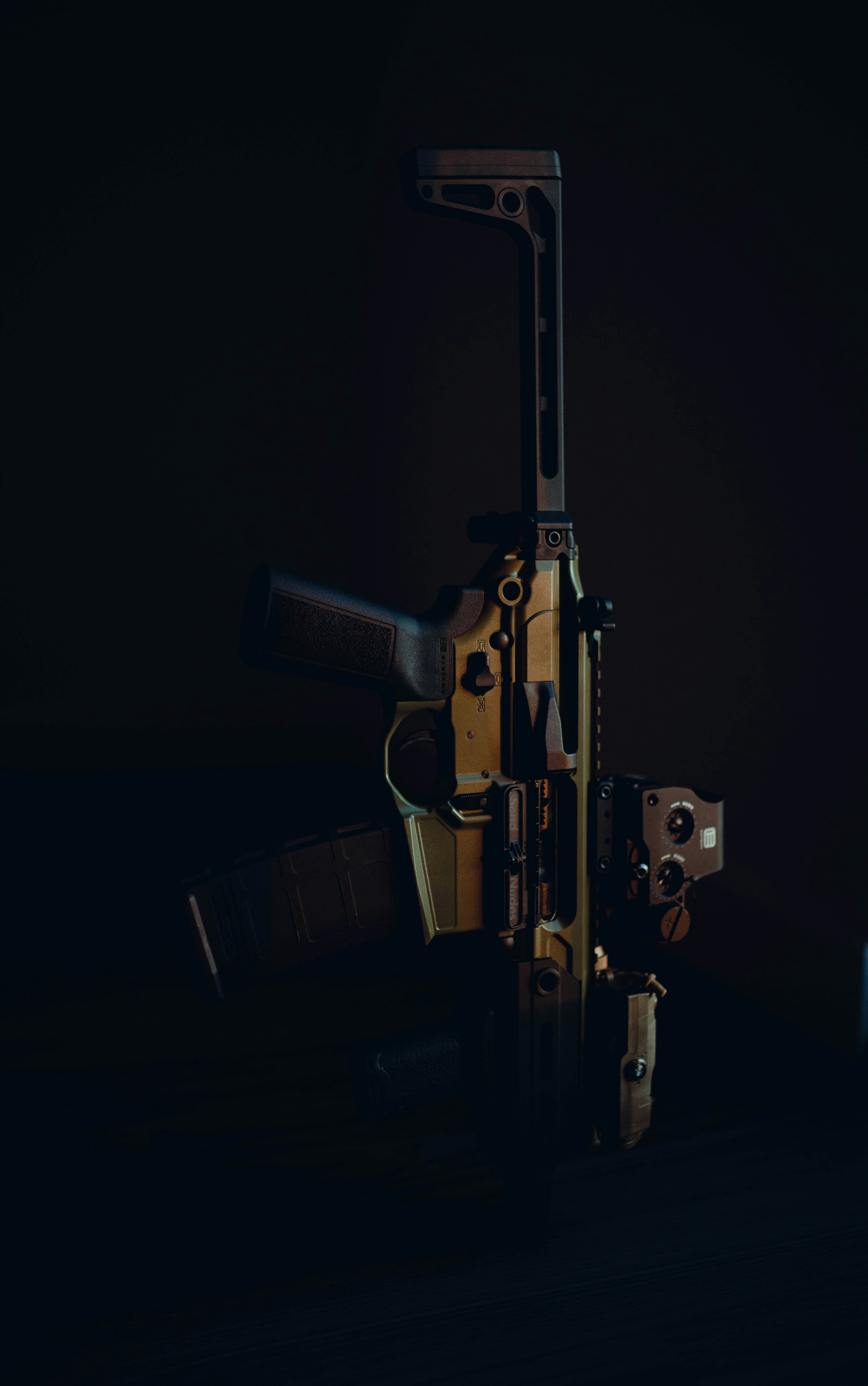 a close up of a gun in the dark