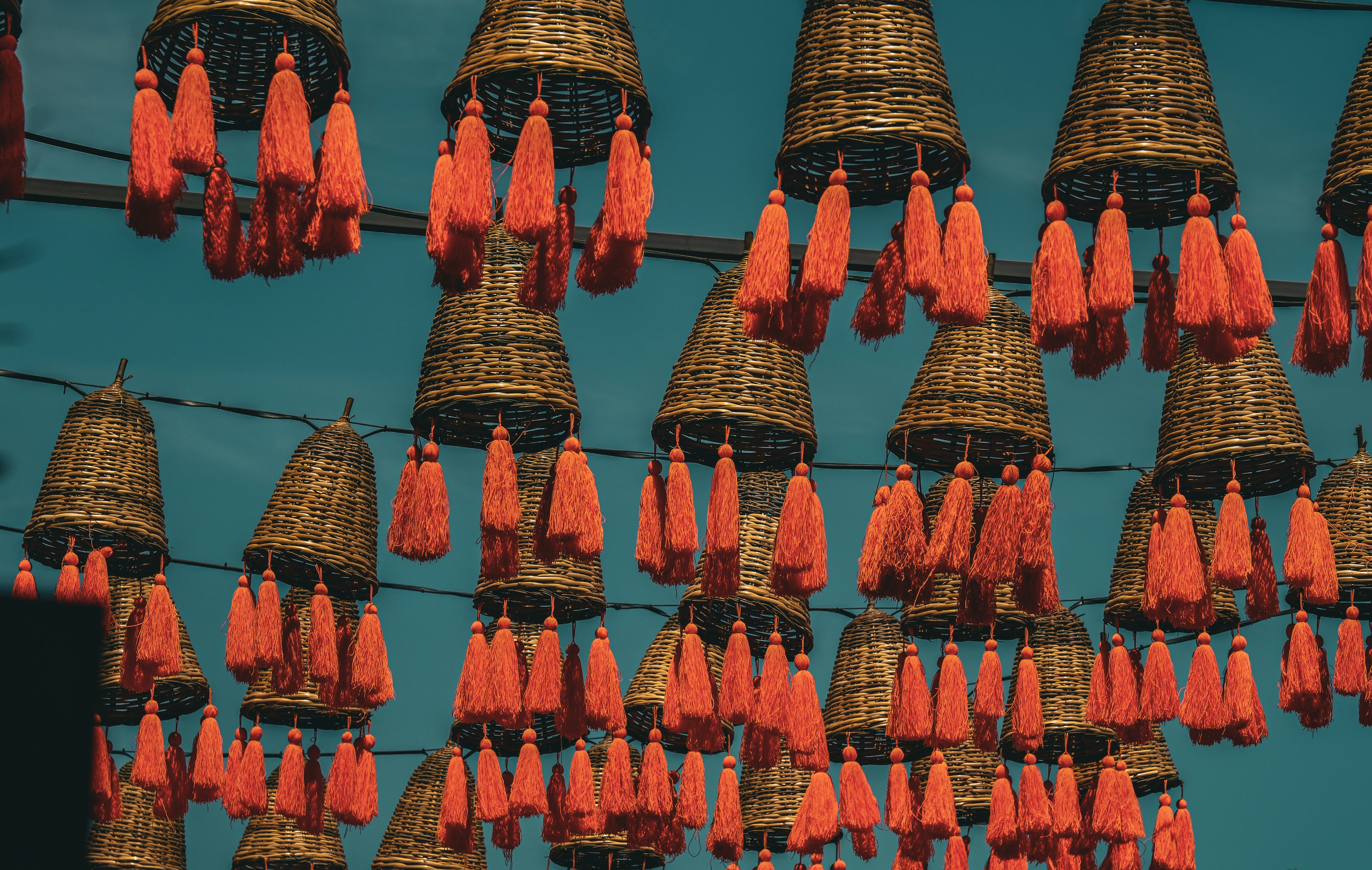a bunch of orange tassels hanging from a wire