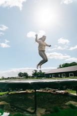a person jumping in the air on a trampoline