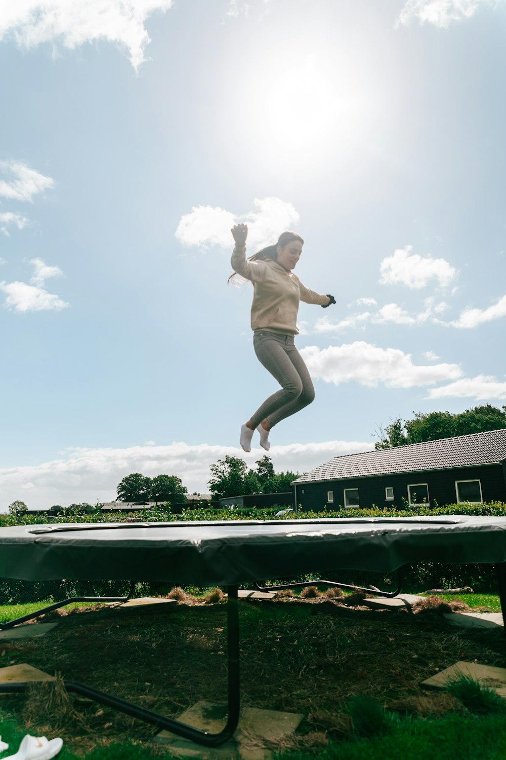 a person jumping in the air on a trampoline