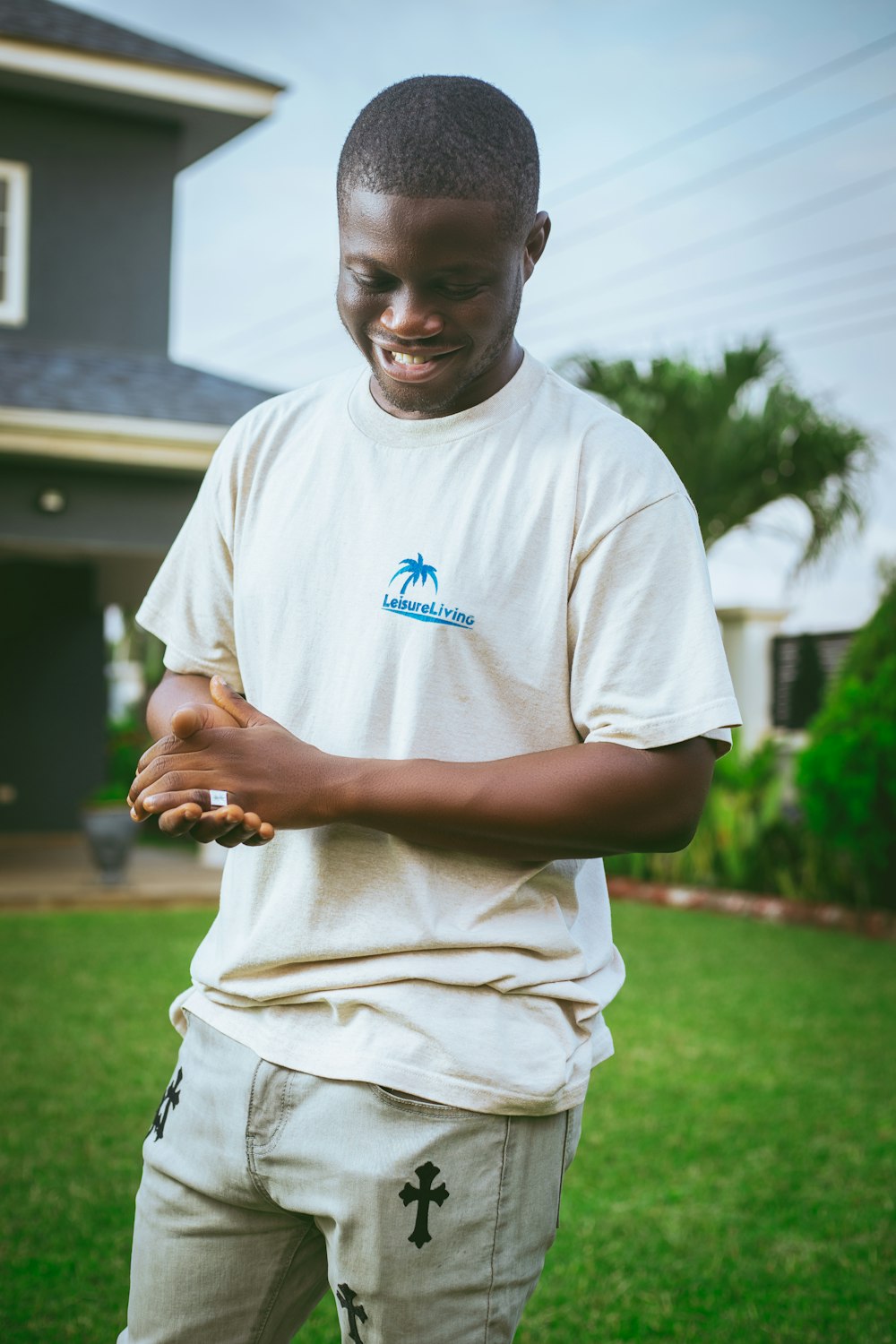 a man in a white t - shirt is holding something in his hands