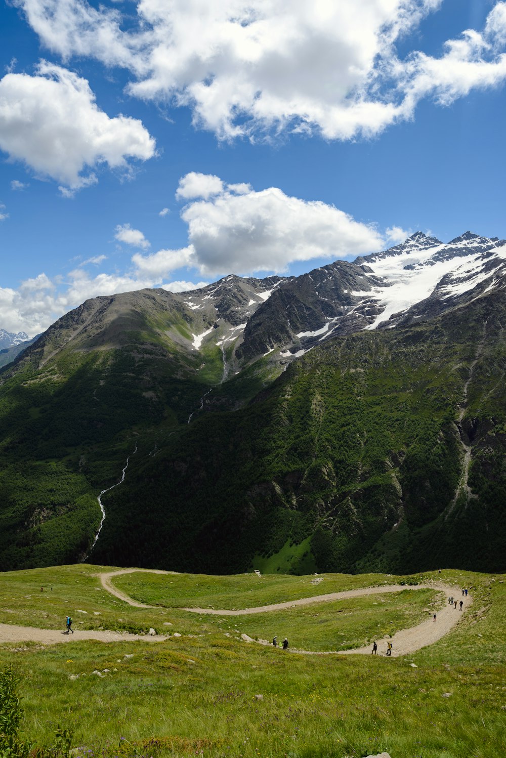 a group of people riding bikes on a trail in the mountains