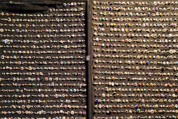 An elegant display of assorted rings on a soft beige fabric.