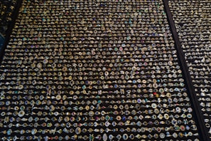 A collection of men's rings in various styles arranged on a marble countertop.