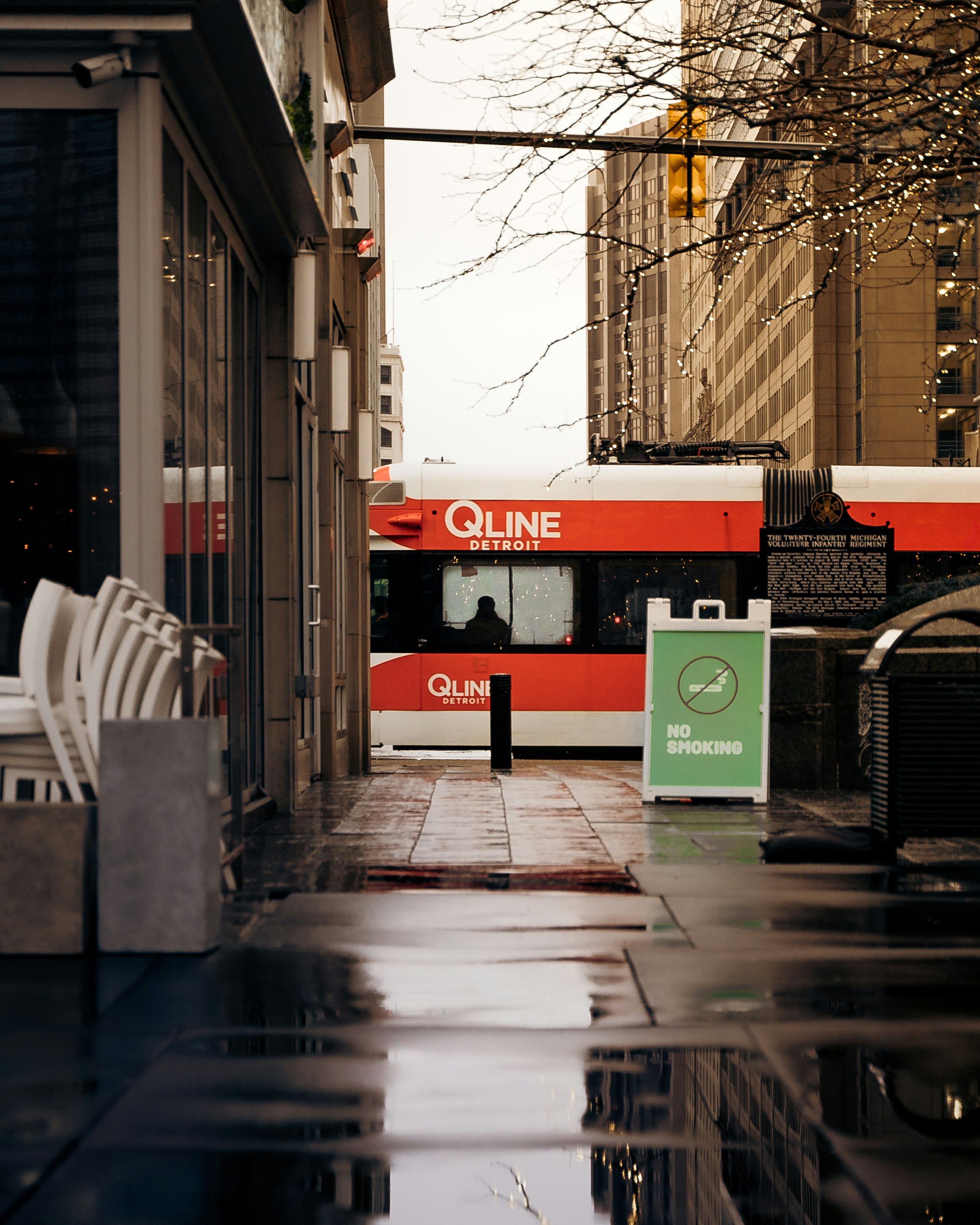 a red and white bus on a city street