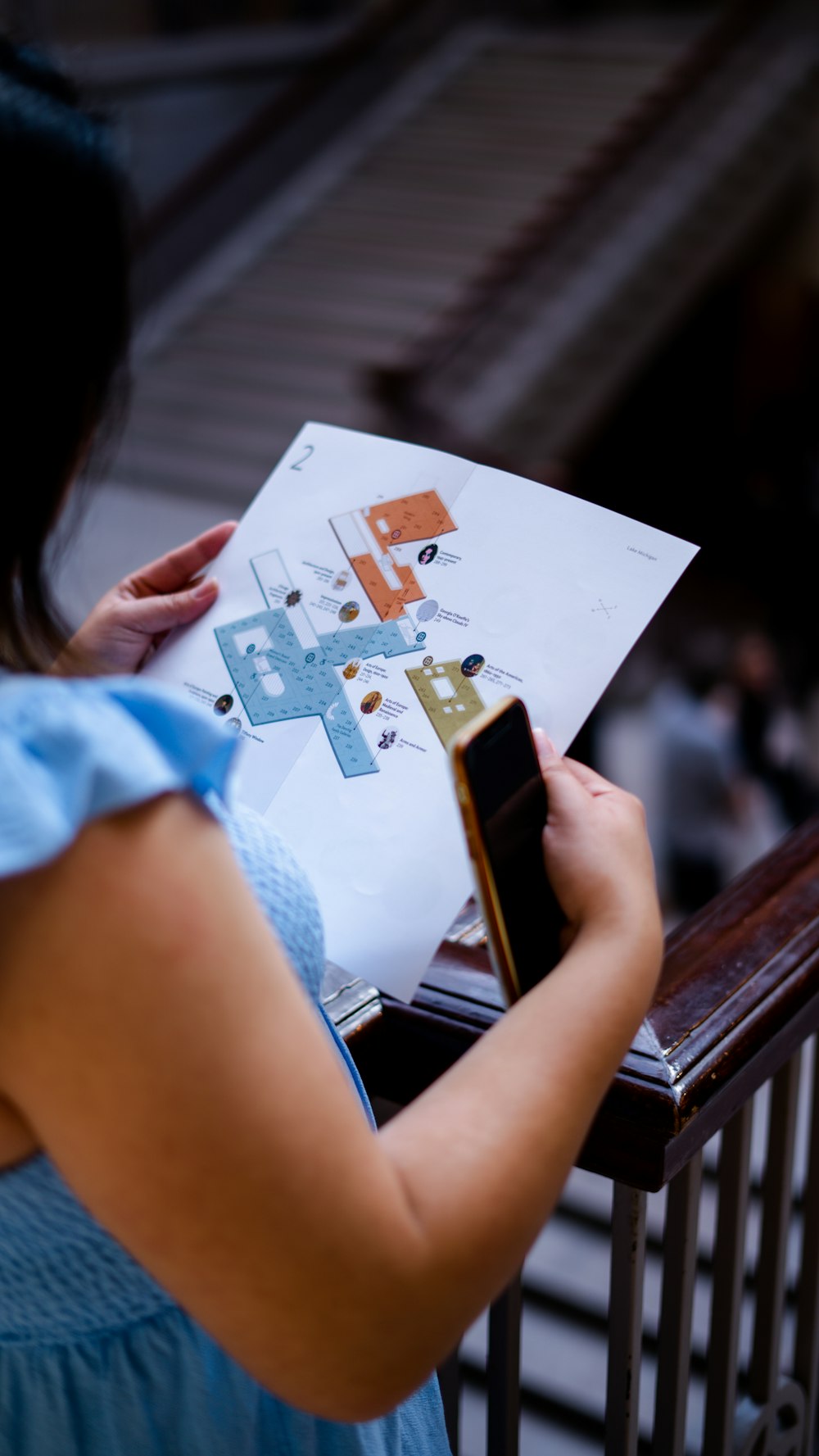 a woman is holding a piece of paper and looking at it