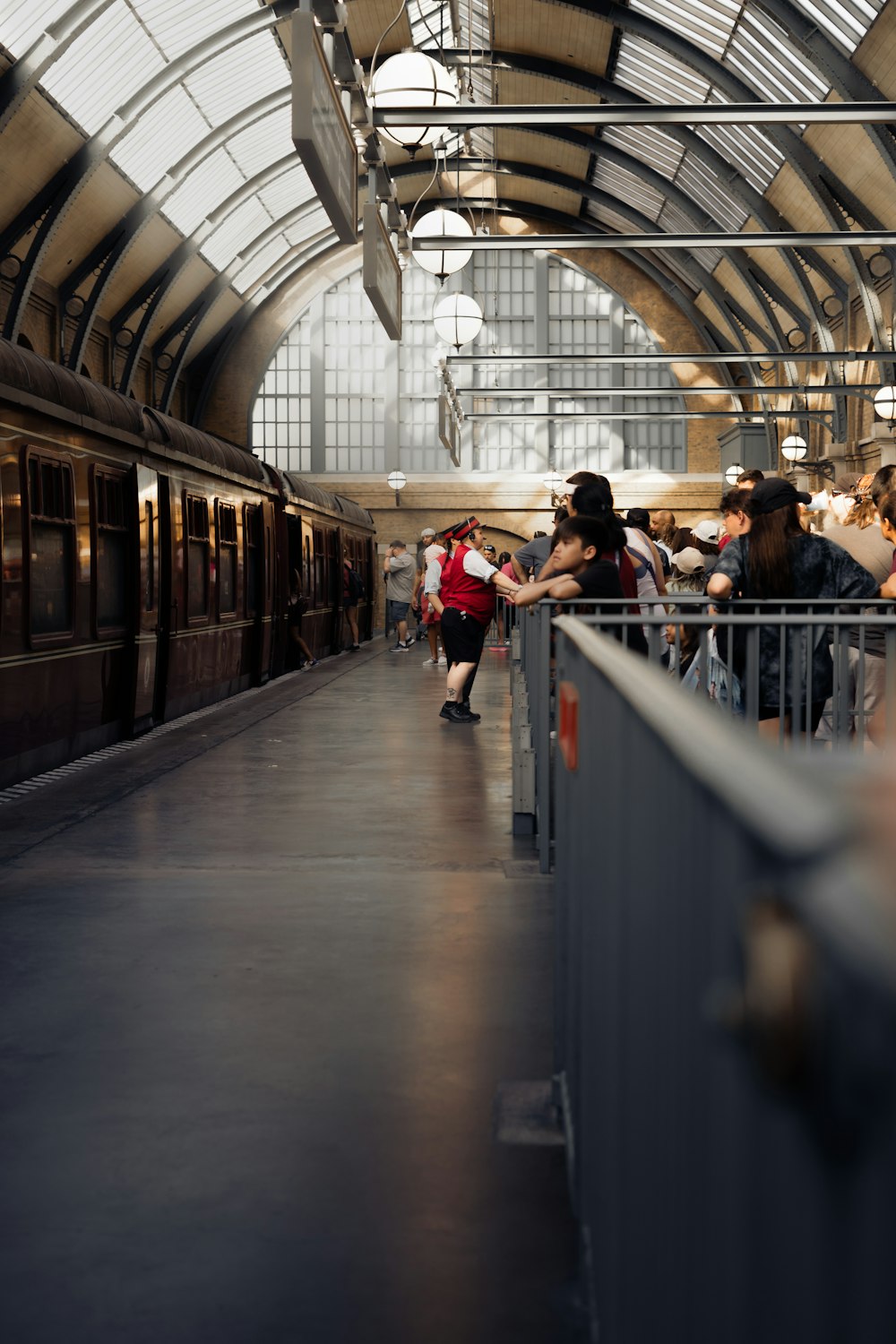 a group of people standing next to a train at a train station