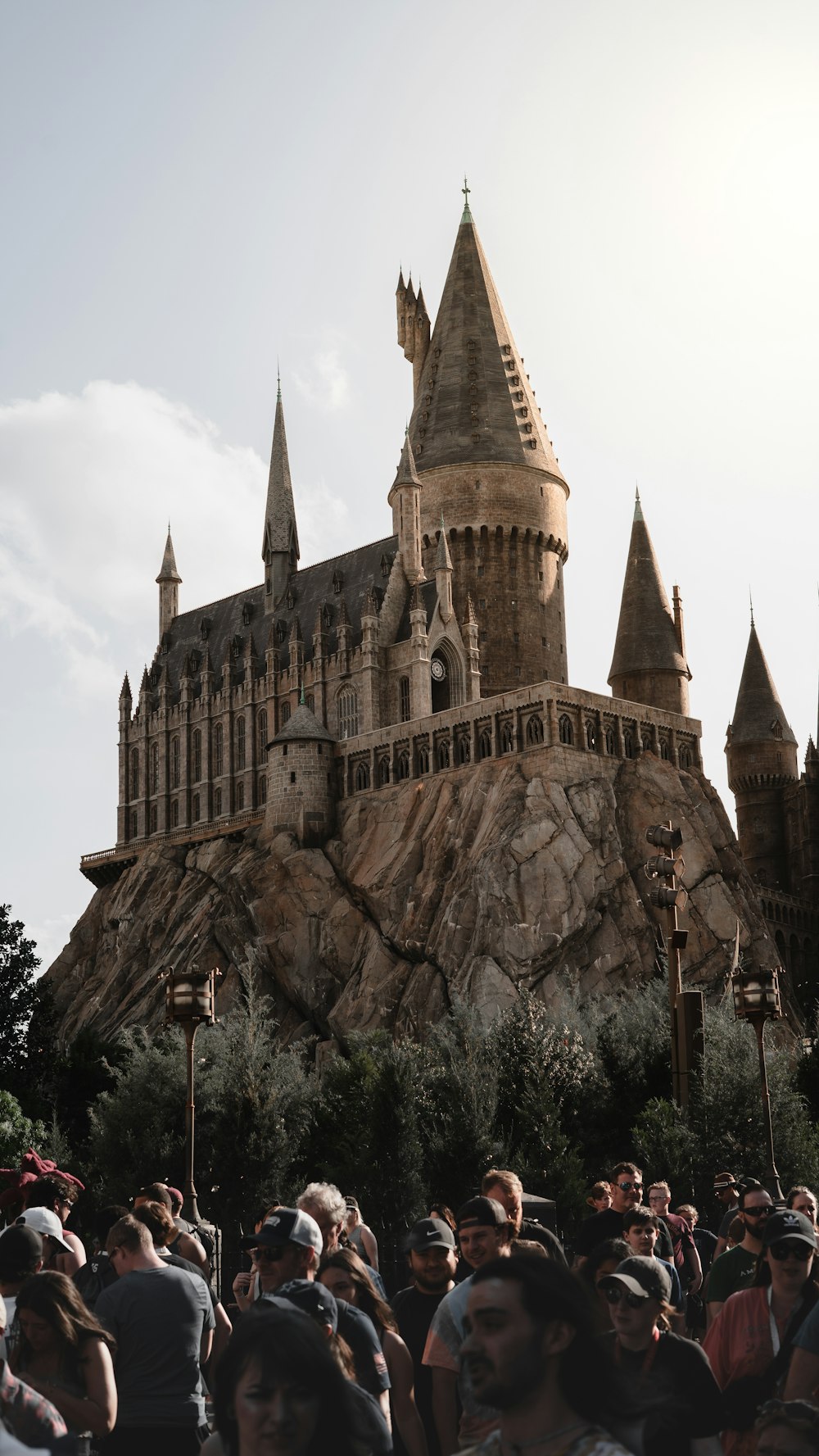 a crowd of people standing in front of a castle