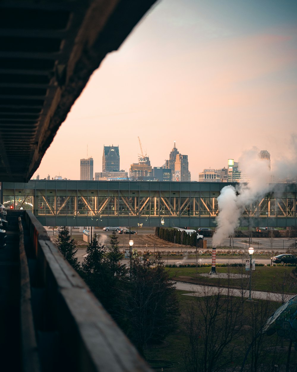 a train traveling over a bridge next to a city