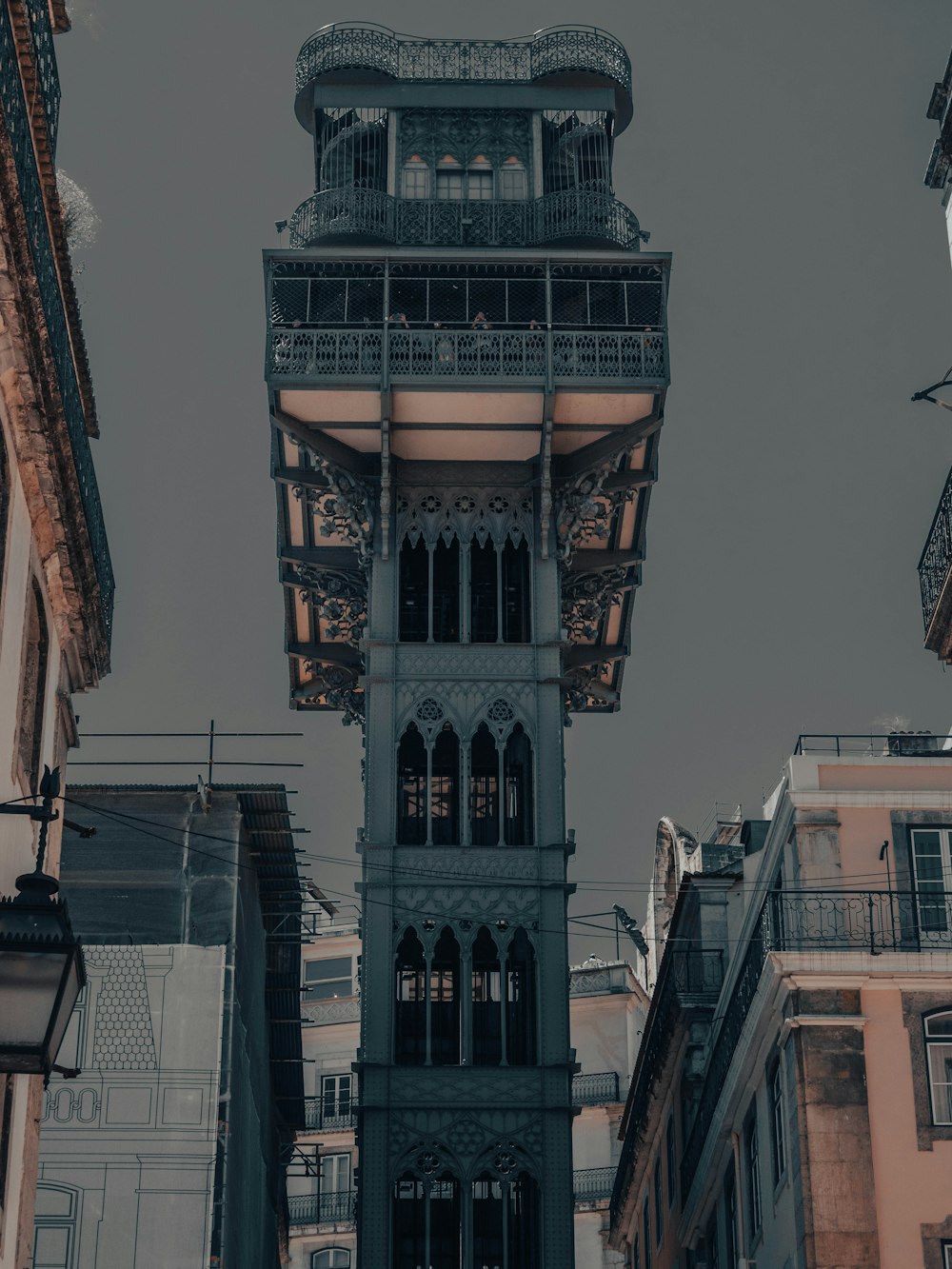 a tall clock tower towering over a city filled with tall buildings