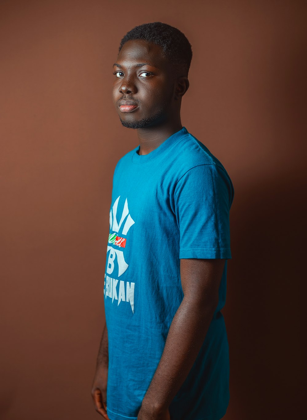 a man in a blue shirt is posing for a picture