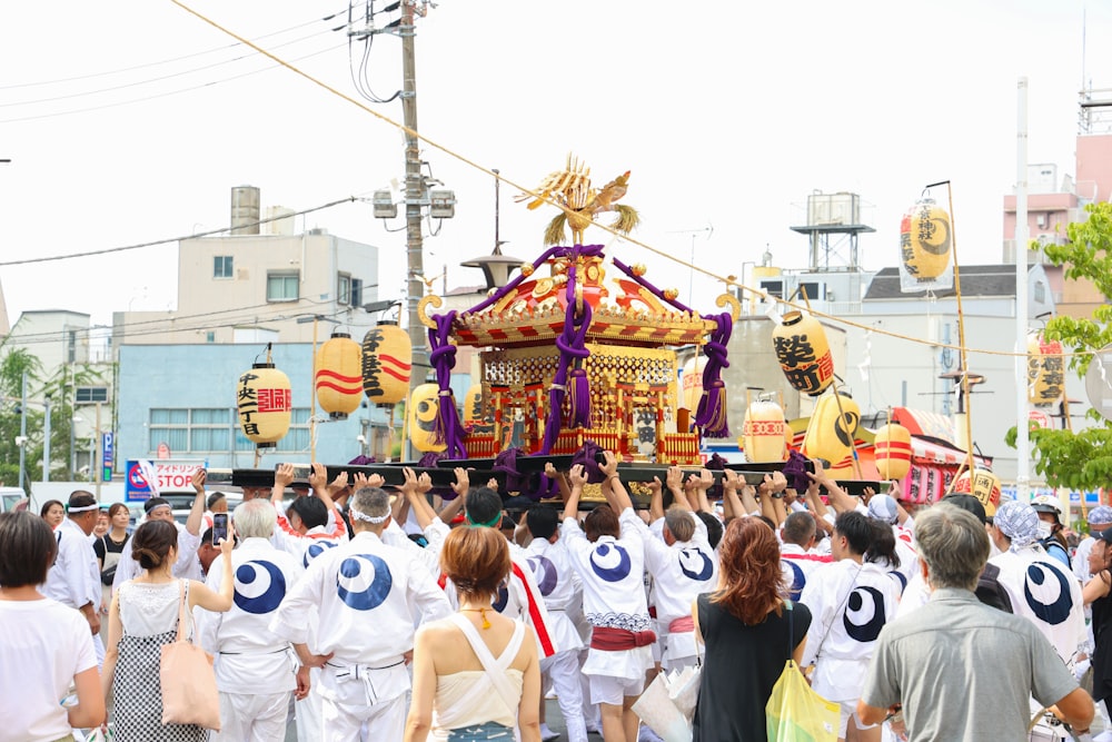 a group of people walking down a street next to a float
