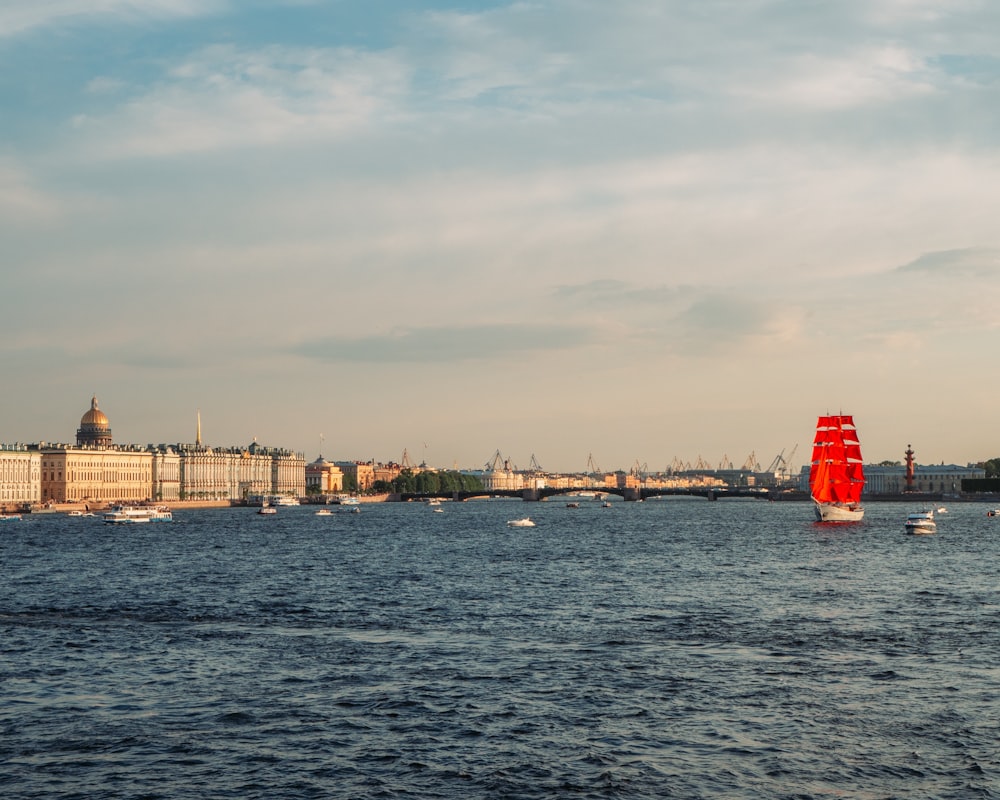 a red sailboat in a body of water