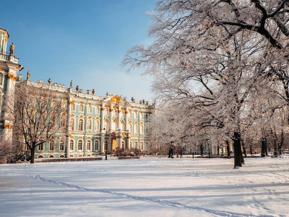 a large building in the middle of a snowy field