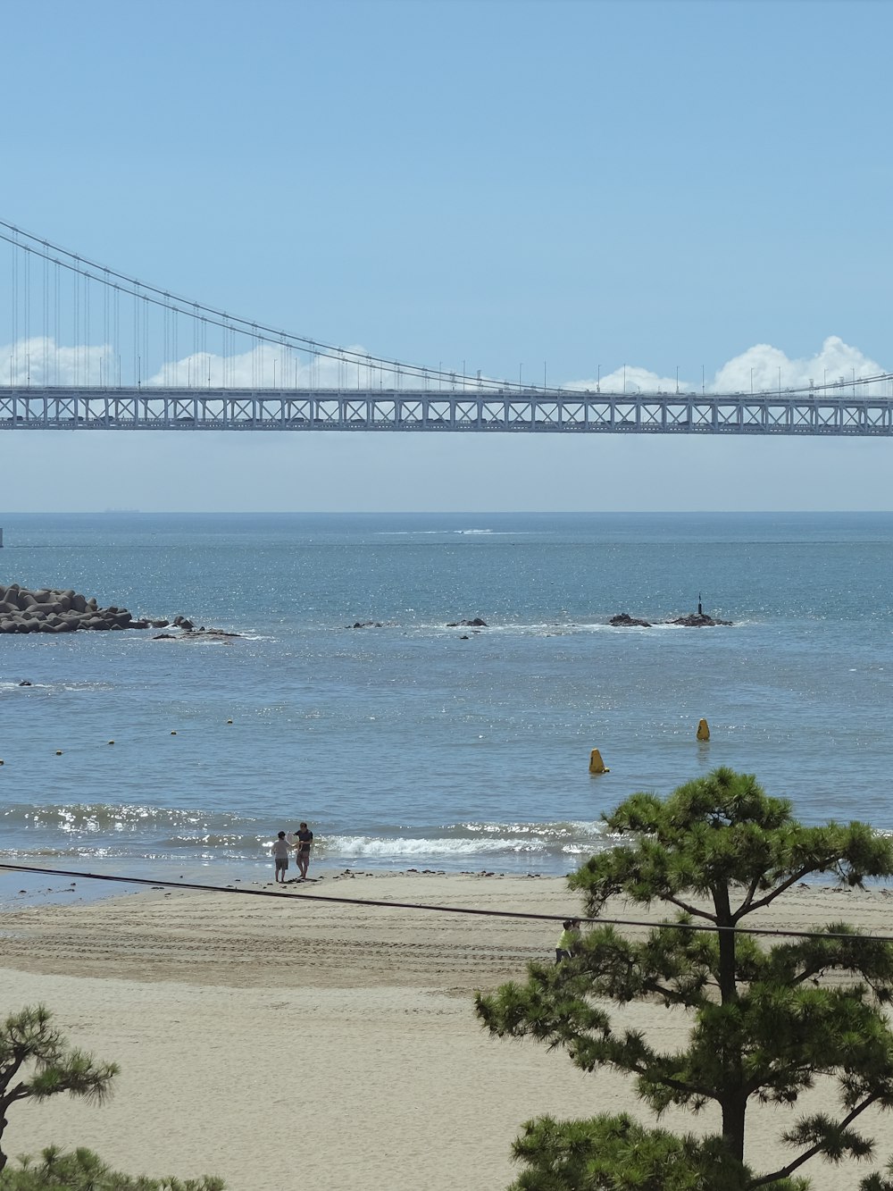 a bridge over a body of water near a beach