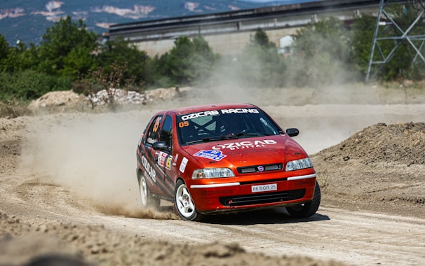 A close-up of a cartoon-style racing game featuring quirky characters competing on a dirt track.