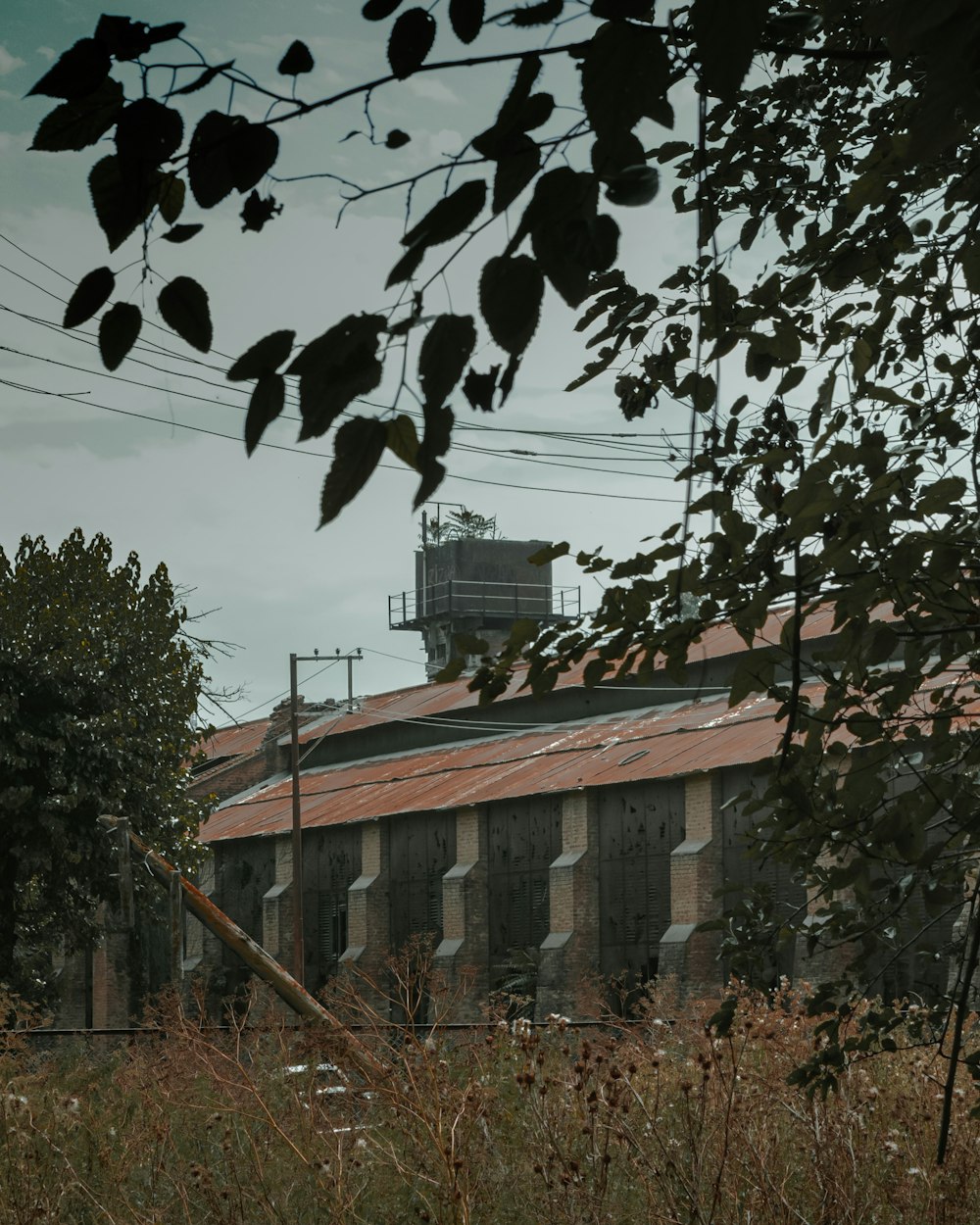 an old factory building with a clock tower in the background
