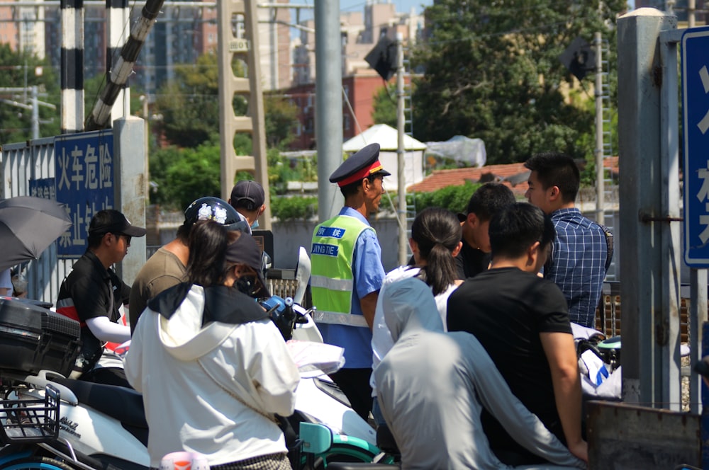 a group of people standing around a motorcycle