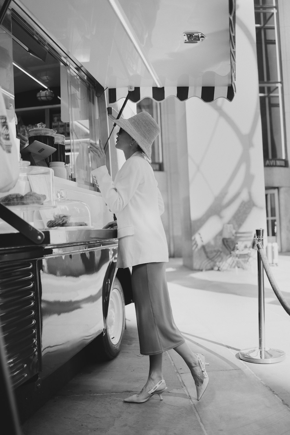 a woman is standing in front of a food truck