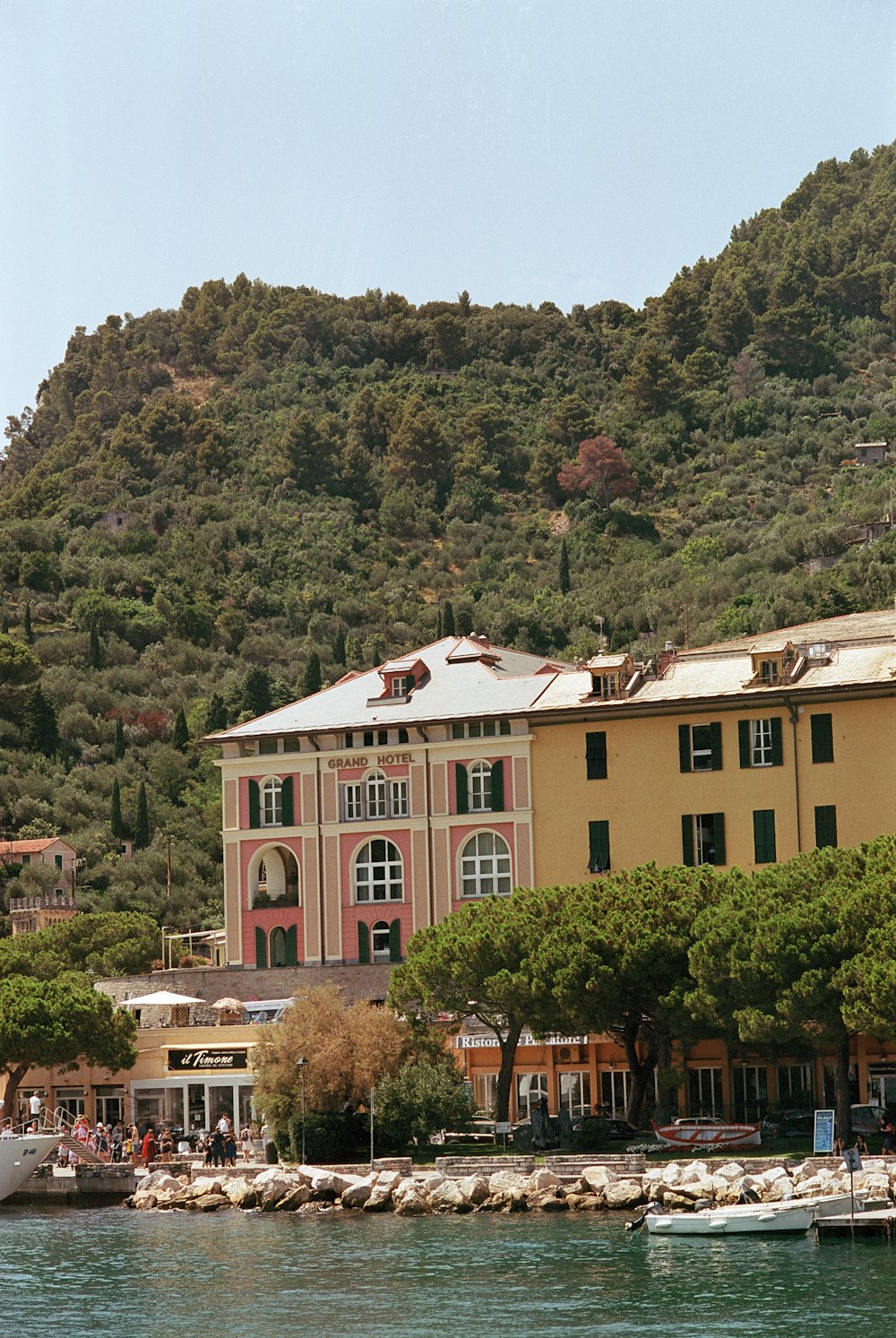 a large building sitting on top of a lush green hillside