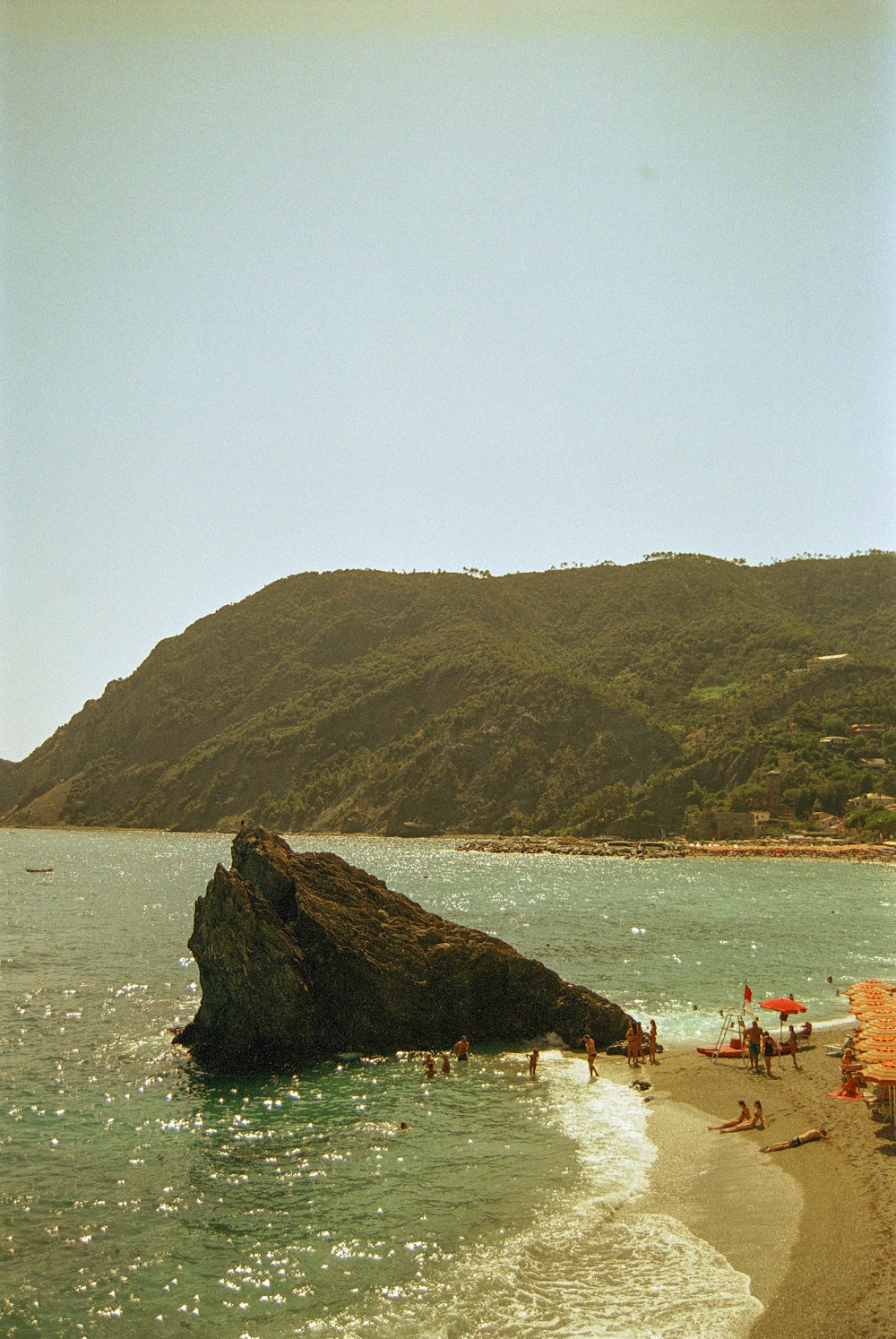 a group of people on a beach near the ocean