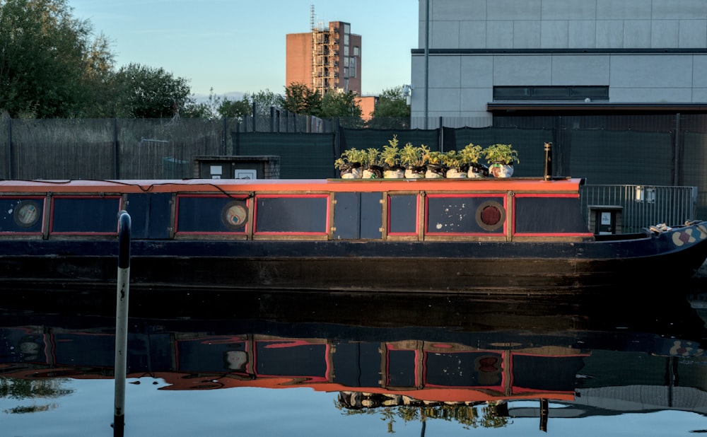 a boat with plants on top of it floating in a body of water