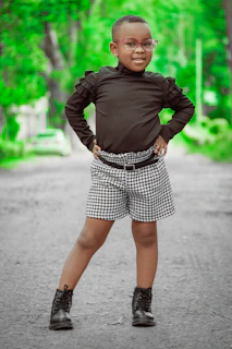 A confident 12-year-old girl posing in a stylish outdoor urban setting, wearing a chic, vogue-inspired outfit.