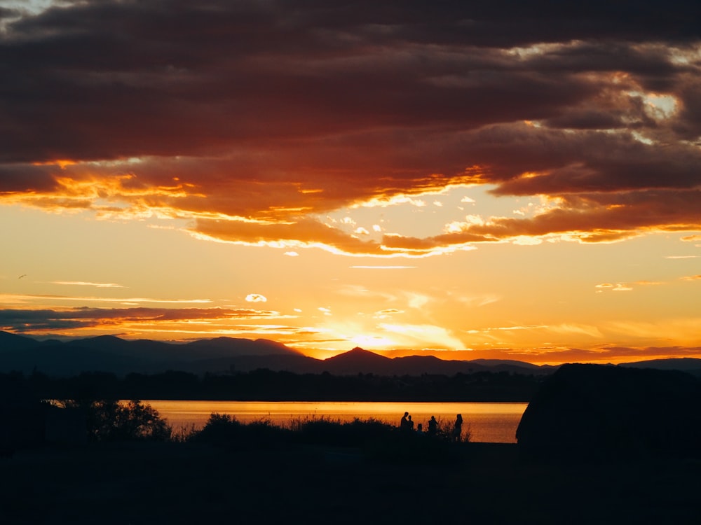 the sun is setting over a body of water