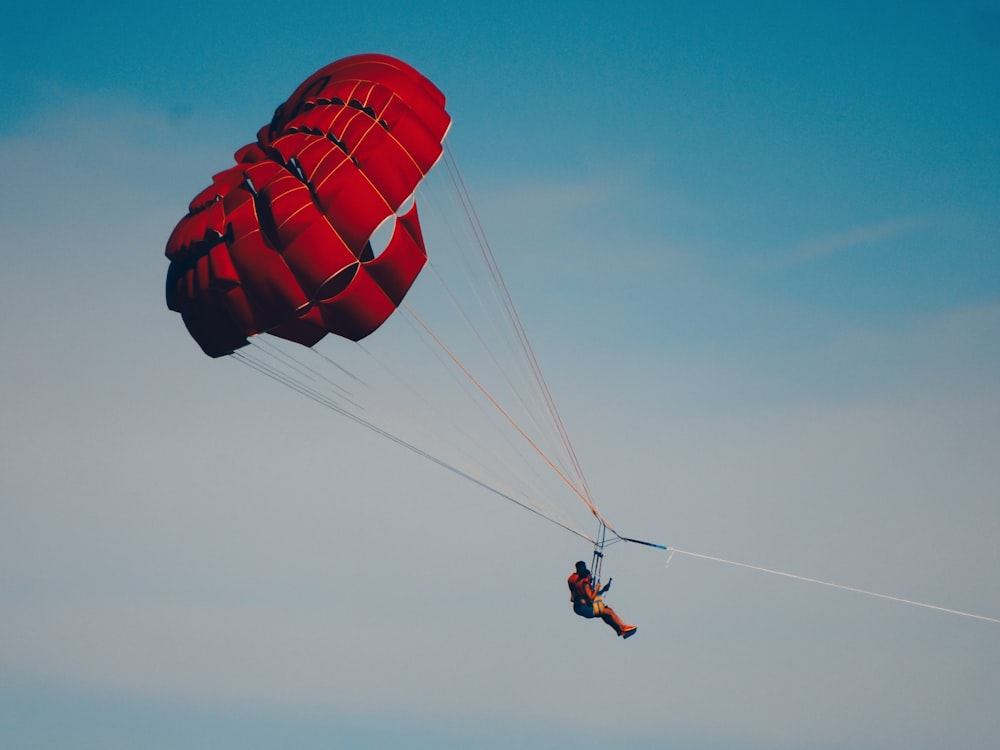 a person is parasailing in the sky on a clear day