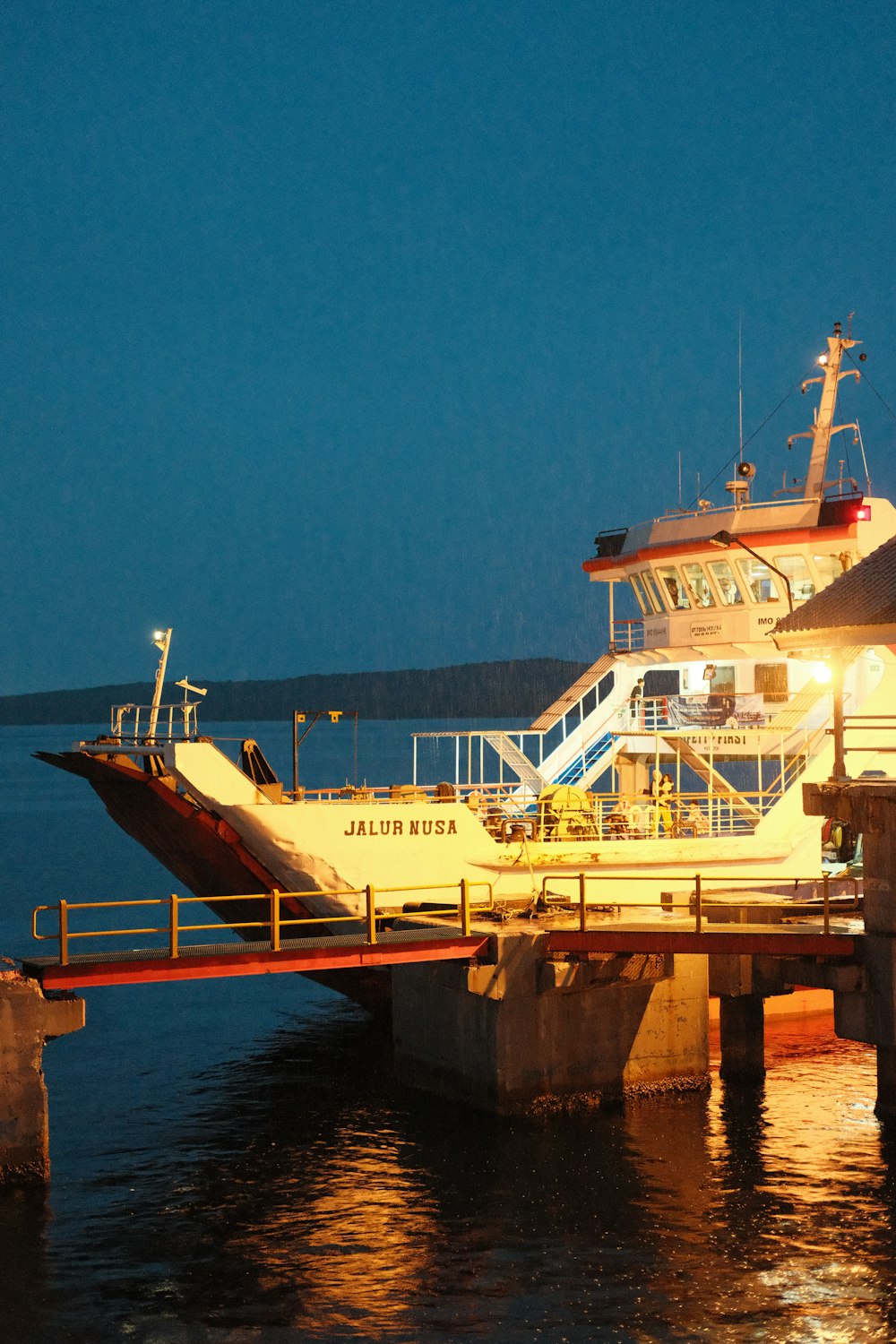 a large boat is docked at a pier