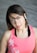 a woman in a pink shirt posing for a picture