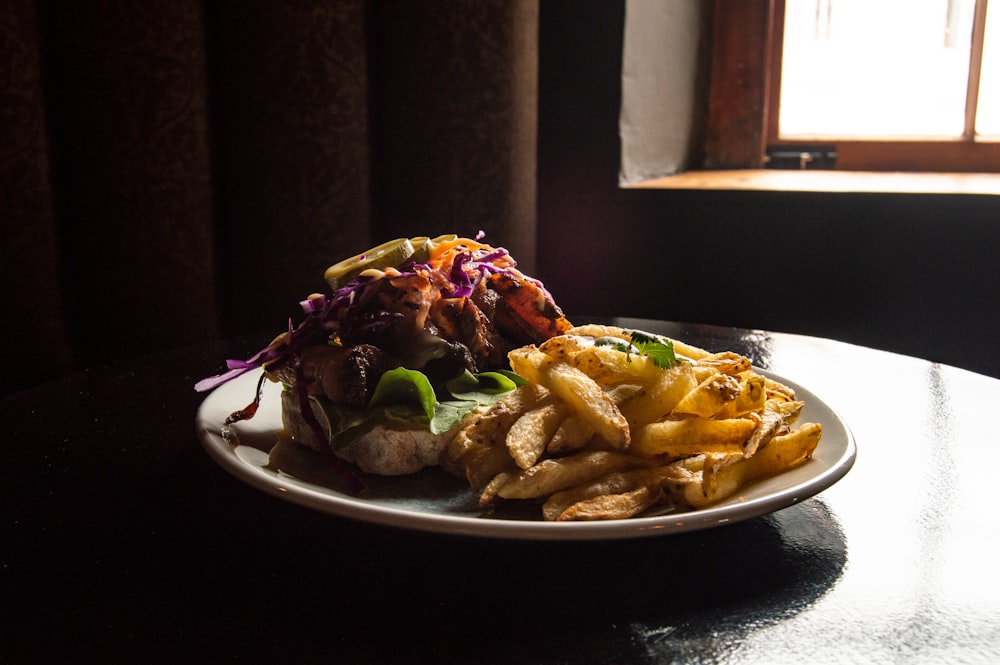 a plate of food on a table with a window in the background