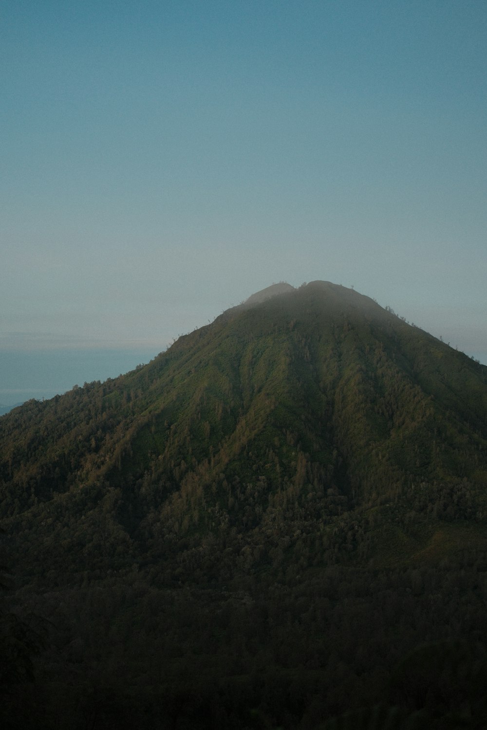 a very tall mountain with a sky background