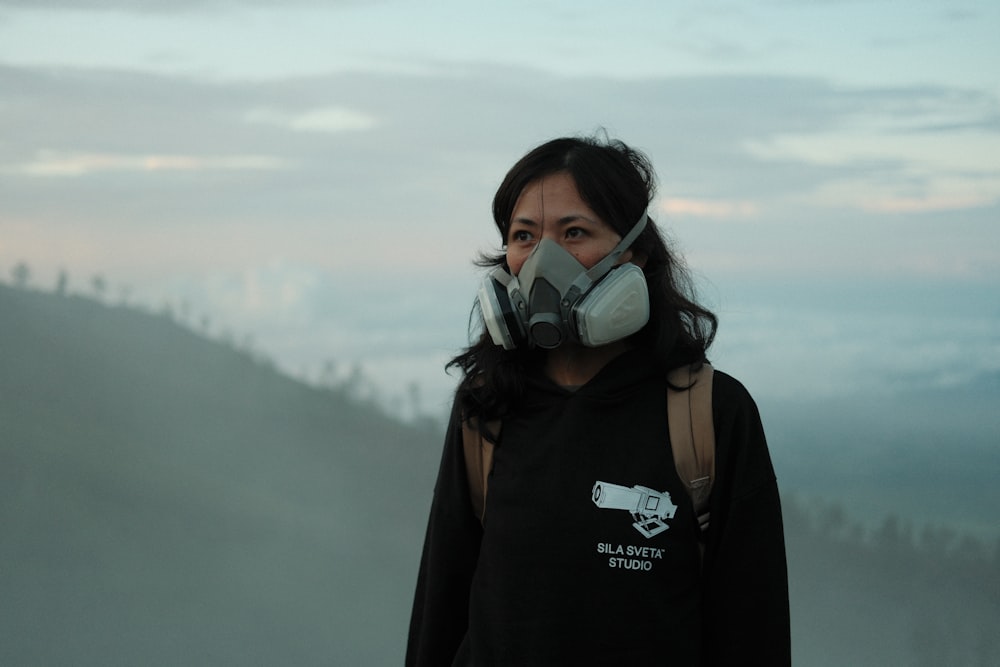 a woman with a gas mask on her face