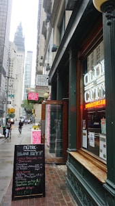 A vibrant street scene in Old City Philadelphia bustling with diners and shoppers.